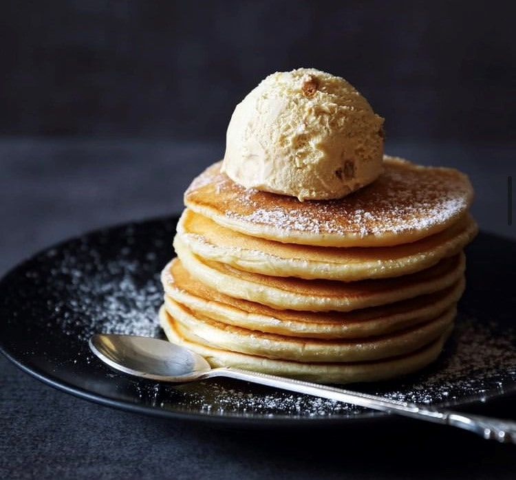 A stack of pancakes with ice cream on as local ice cream parlour introduces delivery service. 