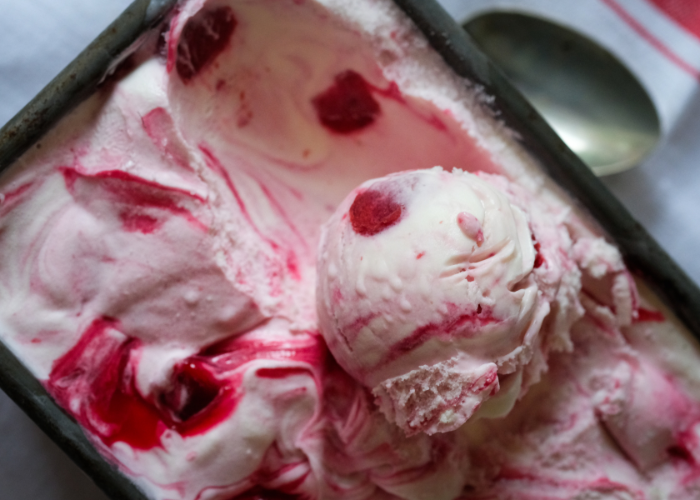An example of a new ice cream flavour, scoop of colourful pink ice cream in its tub.